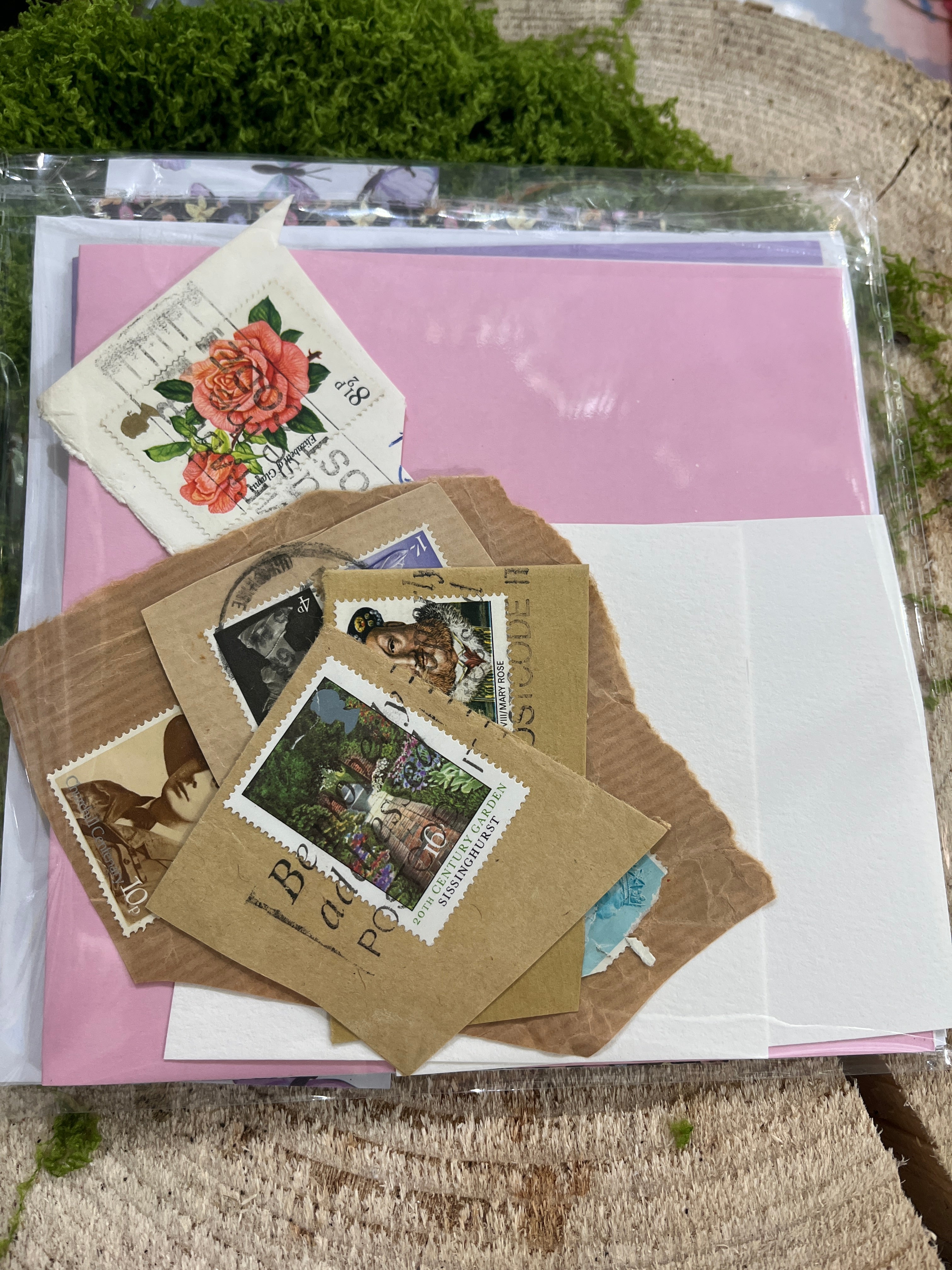 card making craft set, scrap card stickers & stamps, set on a wooden base with greenary around it