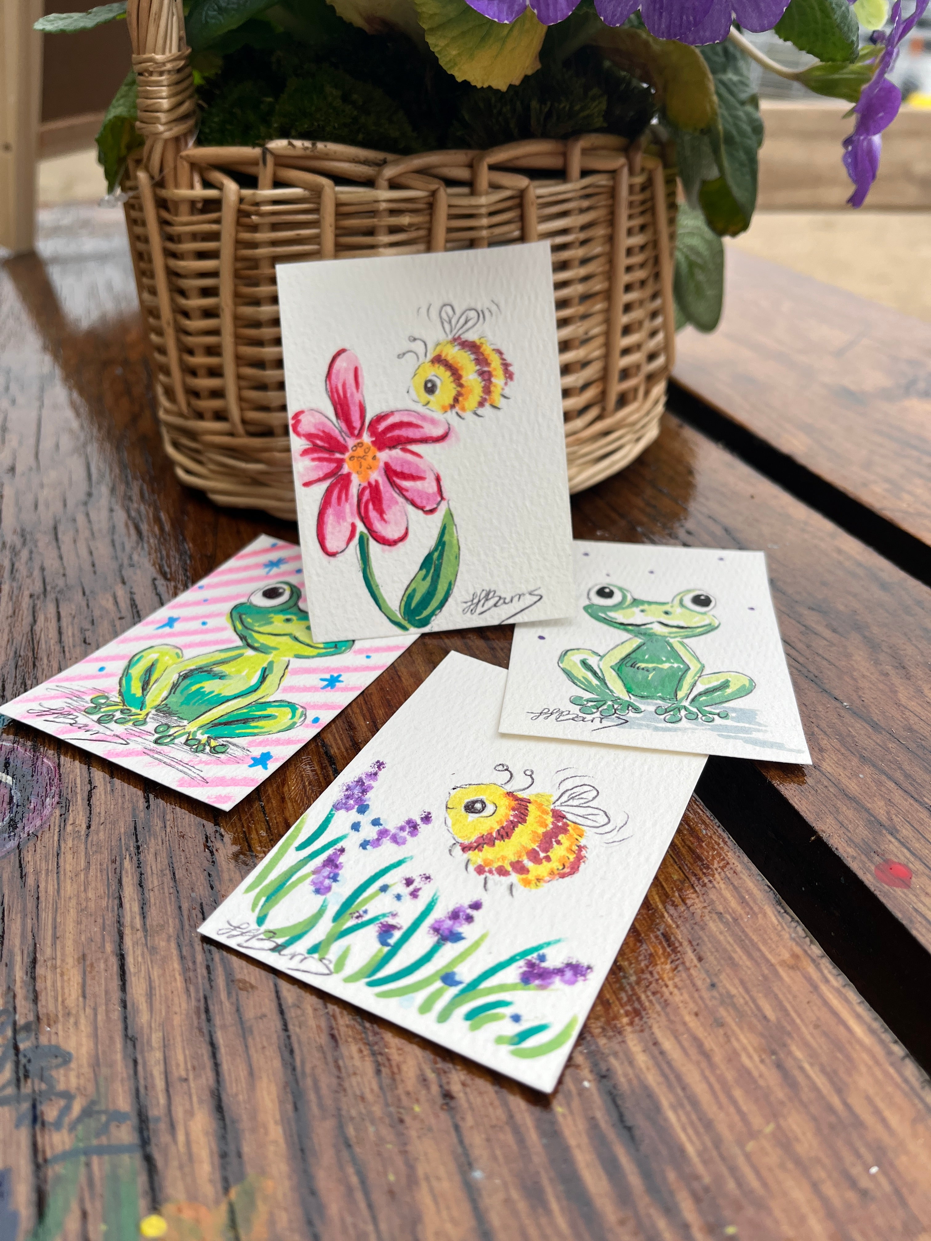 Set of aceo cards with floral bee and frog designs on a wooden surface. for trading or collecting and scrapbooking- the wild fig and fern
